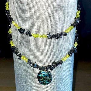 Layered necklace with onyx & light green citrine stones and glass center piece.